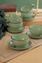 Ceramic teacup and saucer set on kitchen table