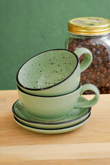 Ceramic teacup and saucer set on kitchen table