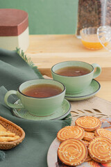 Ceramic teacup and saucer set on kitchen table