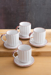 Ceramic teacup and saucer set on kitchen table