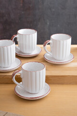 Ceramic teacup and saucer set on kitchen table