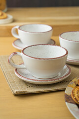 Ceramic teacup and saucer set on kitchen table