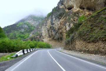 Asphalt with markings on the highway in the mountains. Turns of a beautiful mountain road.