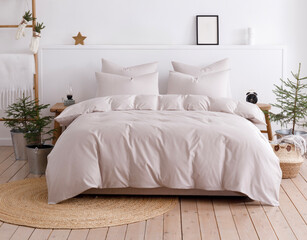 Scandinavian style bedroom with double bed, four pillows and duvet. Front view photo