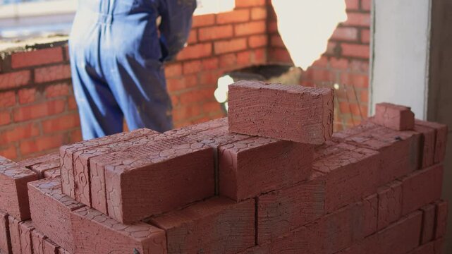 Bricklayer Hard at Work Ongoing Construction of a Residential Building Structure