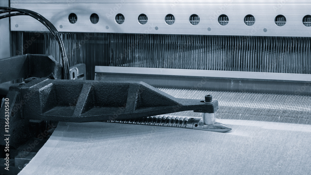 Aufkleber a machine is weaving a piece of fabric. the machine is made up of many parts, including a large meta