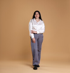 Smiling plus size model on beige background. Overweight