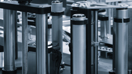 Fragment of the conveyor of sticking labeling machine. Abstract industrial background.