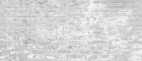 Fototapeta premium A brick wall as white background. The wall is covered in white paint and has a rough texture
