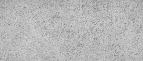 A grey wall with a lot of small dots. The wall is very plain and has no design