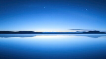 Tranquil Blue Lake Reflecting the Night Sky at Dusk with Stars in a Peaceful Landscape