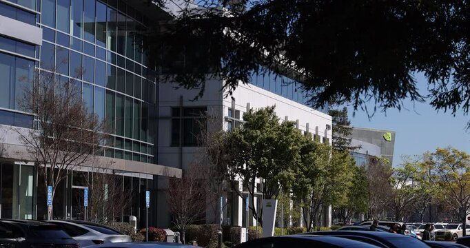 Santa Clara, California, USA - March 24, 2025: People walk on the campus of the downtown corporate NVIDIA headquarters.