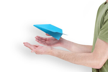 hand of young man with blue paper plane taking off