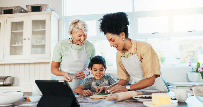 Tablet, family and mother baking with child in kitchen for online cookie recipe, video tutorial or development. Happy people, grandmother and teaching boy with dessert, snack preparation and learning