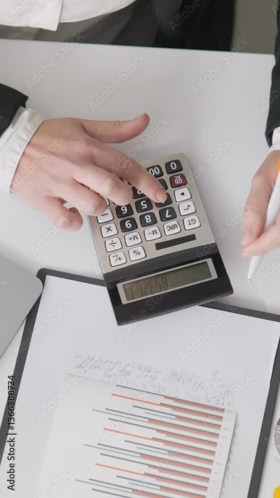 Poster a skilled professional is focused on complex financial calculations with a calculator, surrounded by
