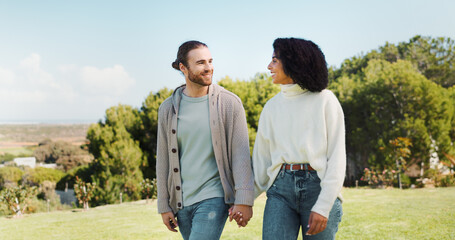 Love, holding hands and smile with couple in park for relax, date and romance. Outdoor, walking and...