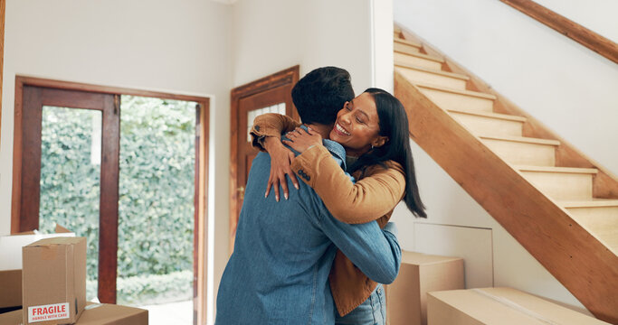 Hug, couple and excited in new home for real estate, investment and freedom or financial security. Happy man, woman and celebration in embrace for moving house, property ownership or mortgage loan
