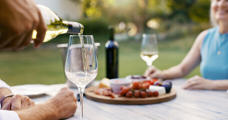 Hand, pouring wine and couple on date with romance, anniversary celebration and breakfast picnic....