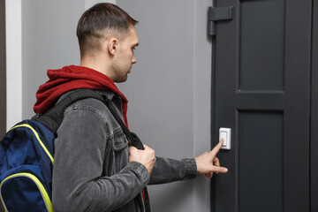 Man ringing doorbell of his friends apartment