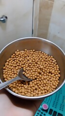 Obraz premium Closeup of Brown Seeds in Metal Bowl