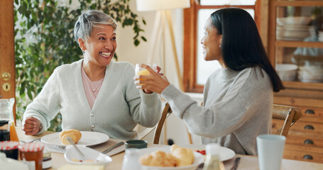 Home, breakfast and senior mother with adult daughter, cheers and bonding together. Family, parent and women with juice, healthy food or nutrition with announcement, good news and happiness with love