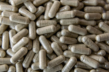 Green transparent tablets or pills on the white background.