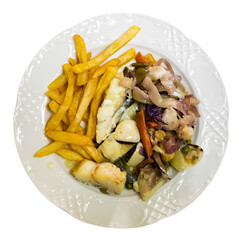 Baked hake fish fillet with French fries and stewed vegetables. Isolated over white background