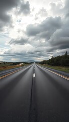 Fototapeta premium Panorama view of asphalt road stretching to horizon under cloudy sky, white, path, background