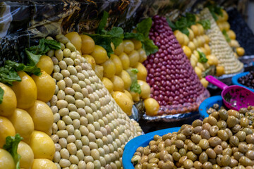Colourful olives and fruit for sale in the souk bazaar in Meknes, Morocco. Photographed in the kissaria, covered market.