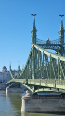 Fototapeta premium BUDAPEST, HUNGARY - January 2024: Panoramic view of the Liberty Bridge or Freedom Bridge as it is also known, which crosses the River Danube in Budapest