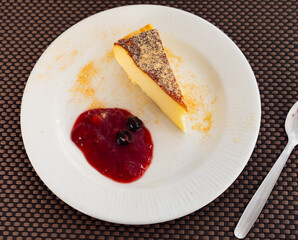 Classic cherry cheesecake served with sweet berry sauce in cafe