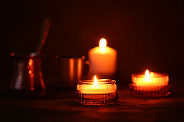 Beautiful burning candles on black background
