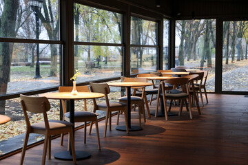 Stylish cafe with large windows and comfortable furniture. Interior design
