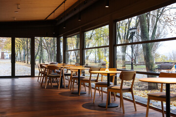 Stylish restaurant with large windows and comfortable furniture. Interior design