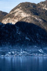 Bright sunny winter day, Alps, Hallstatt lake and village view.