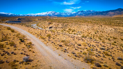 Aerial Desert Road and Snow-Capped Mountains Nevada