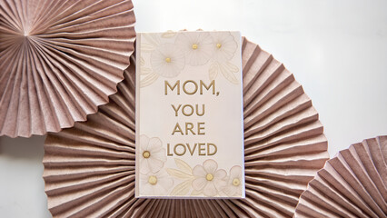 Greeting card for Mom with heartfelt message against decorative backdrop