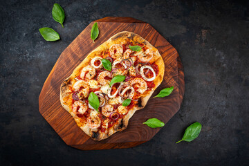 Traditional Italian pinsa bread prosciutto e salsa di pomodoro with seafood, buffalo mozzarella and...