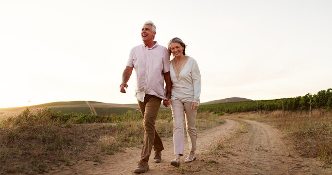 Countryside, walking and holding hands with senior couple, romance and relationship with vacation for honeymoon. People, space and outdoor with old man, mature woman and farm with marriage and love - Powered by Adobe