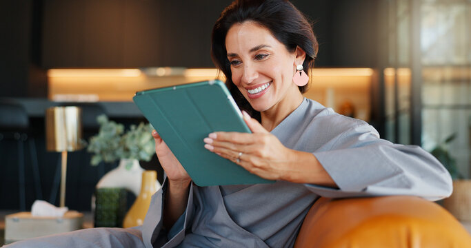 Online booking, smile and tablet with woman in spa for appointment or schedule. Agenda, hospitality and wellness with happy person checking calendar in luxury beauty salon for cosmetic treatment