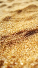 Close-up view of textured, light brown sand on beach
