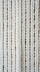 Knitted white texture with a pattern of braids vertical