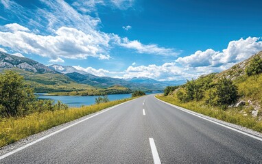 Driving Scenic Road Along Lake and Mountains Under Blue Sky Scenery