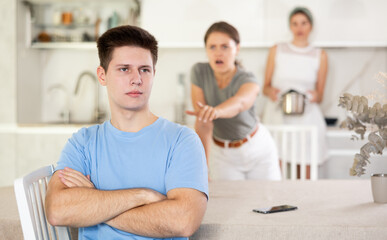 Obraz premium Quarrel of mom, girl and guy. Woman and girl shouts at guy and accuses her