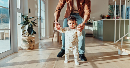 First steps, learning or walking with parent and toddler in home for child development or growth. Balance, mobility support with person teaching baby how to move in apartment for motor skills