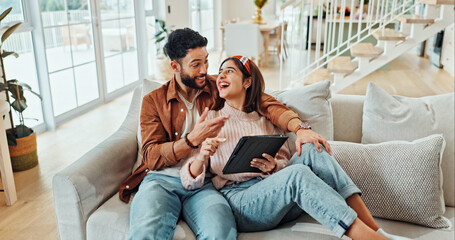 Home, funny and couple on sofa, tablet and bonding together with happiness in living room....