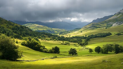 Obraz premium Vast green valleys and rolling hills under a dramatic cloudy sky in the heart of a tranquil mountainous landscape