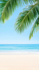 Lush palm fronds frame a tranquil beach scene with a clear blue sky and ocean