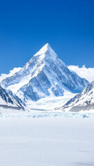 Fototapeta premium Majestic snow-capped peak rises above a glacial lake under a vibrant blue sky