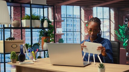 African American woman rebooting the wi fi modem by pulling out cables, checking with the internet...